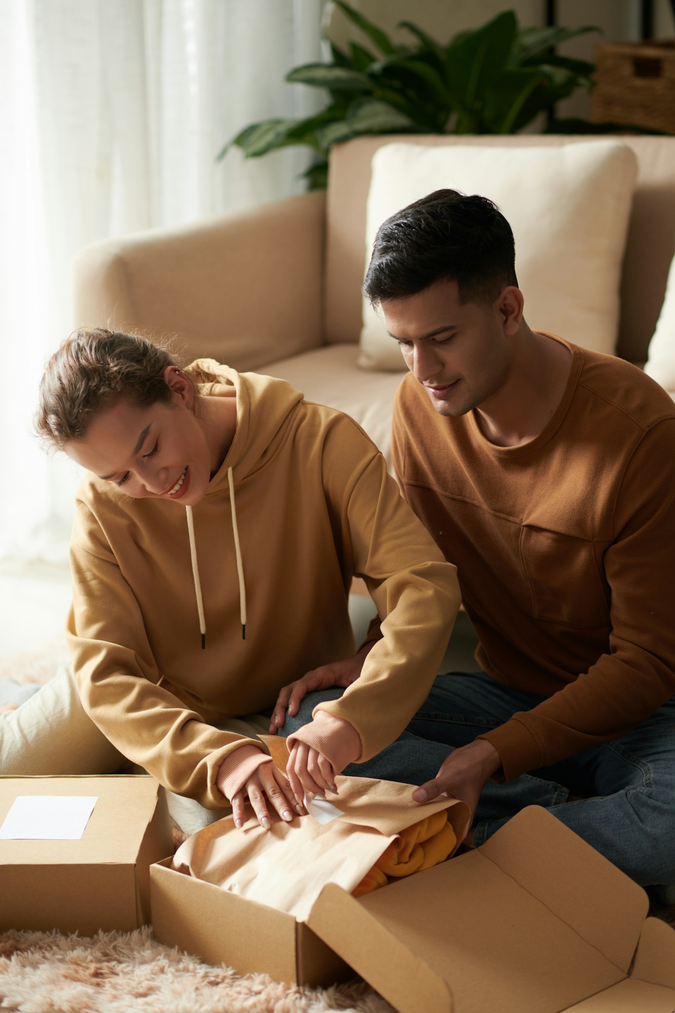 Couple unpacking the box with new clothes